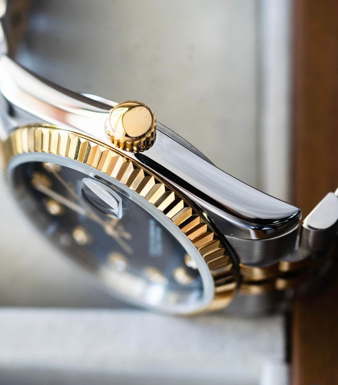 black diamond dial two-tone gold and stainless steel Seiko NH35 mod watch on jubilee bracelet, side angle