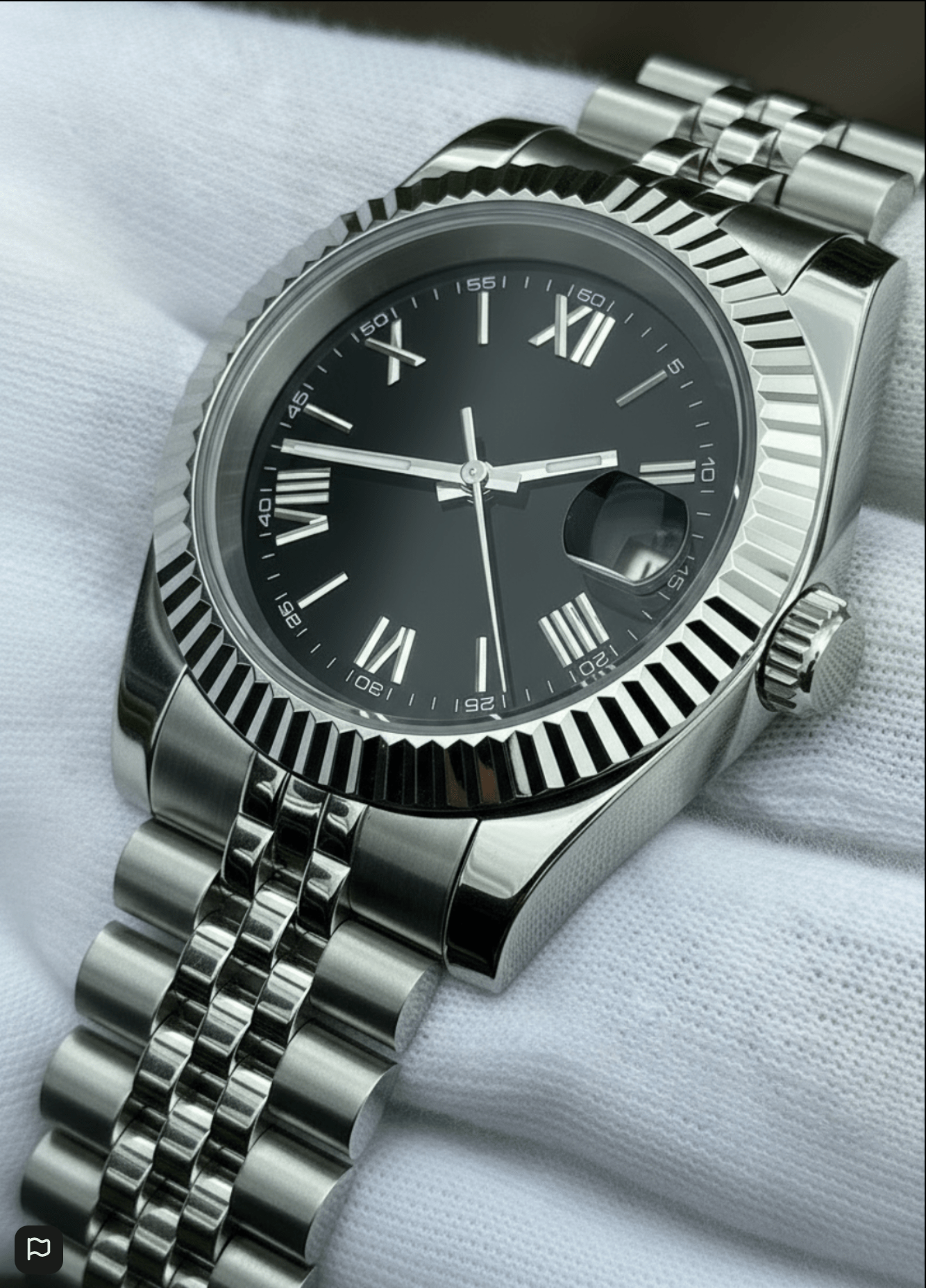 black Roman dial stainless steel Seiko mod watch lying on white cloth, angled view