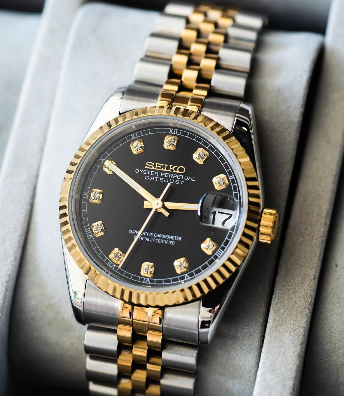 black diamond dial two-tone gold and stainless steel Seiko NH35 mod watch on jubilee bracelet, product shot