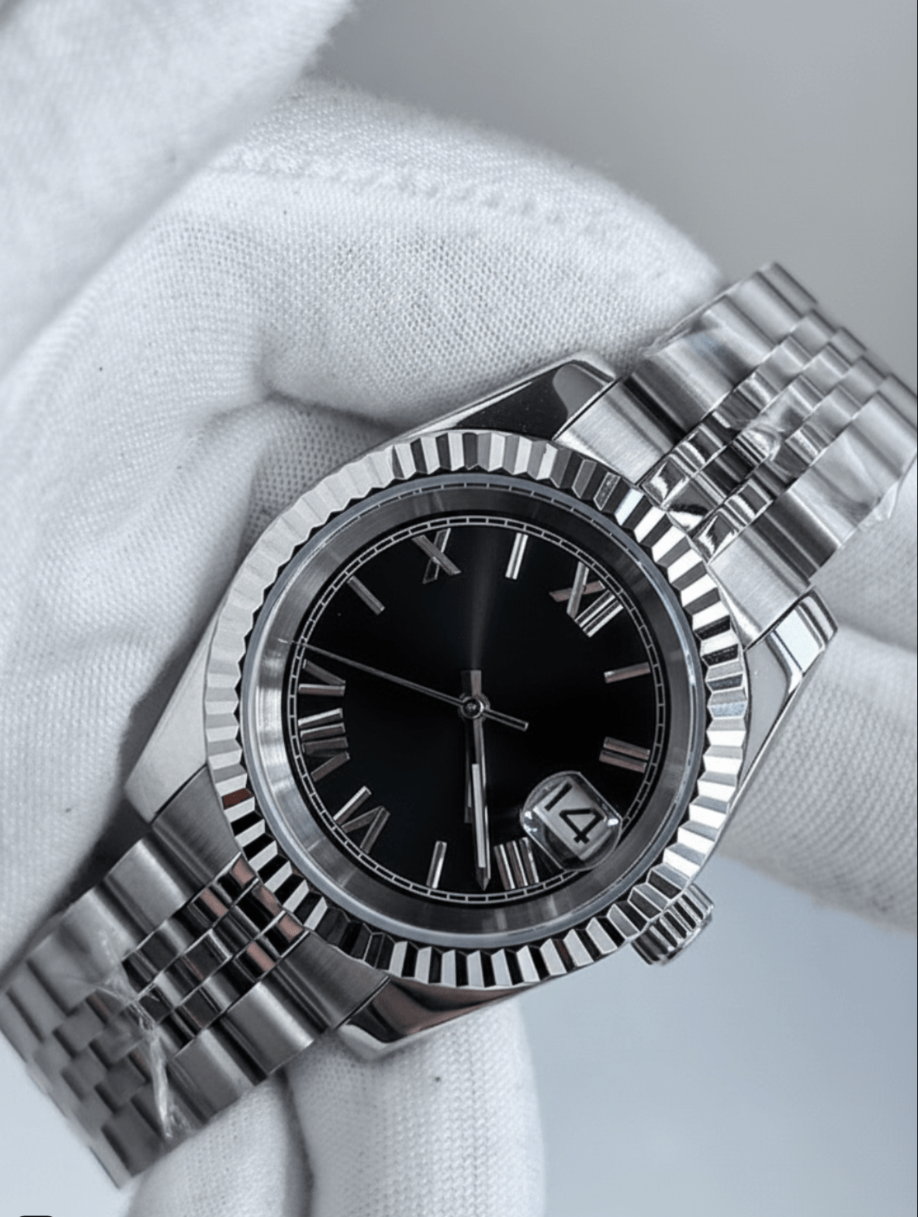 close-up of black Roman dial stainless steel Seiko NH35 mod watch in white gloved hand
