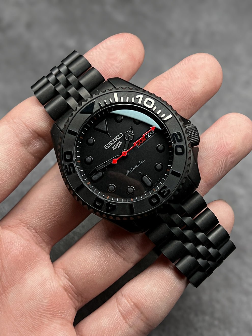 black nautilus seiko mod watch on wrist, 41 mm full black case
