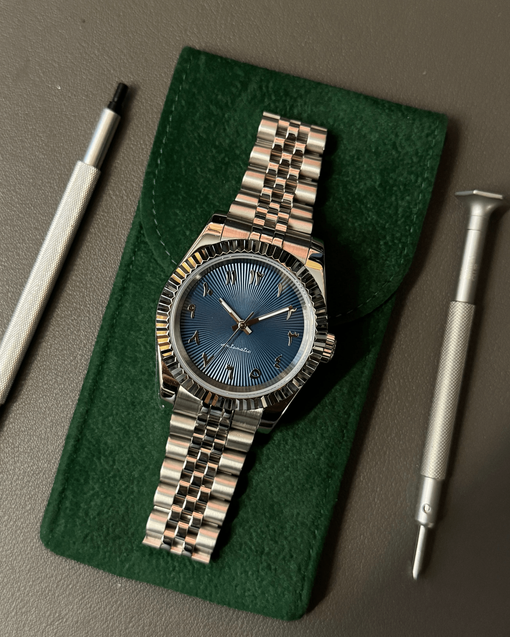 blue Arabic Seiko mod automatic watch with stainless steel bracelet, product shot