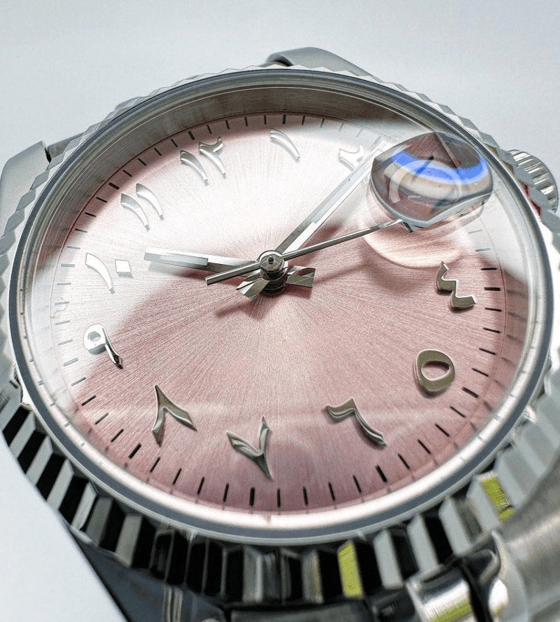 pink Arabic Seiko mod automatic watch with stainless steel bracelet, dial shot