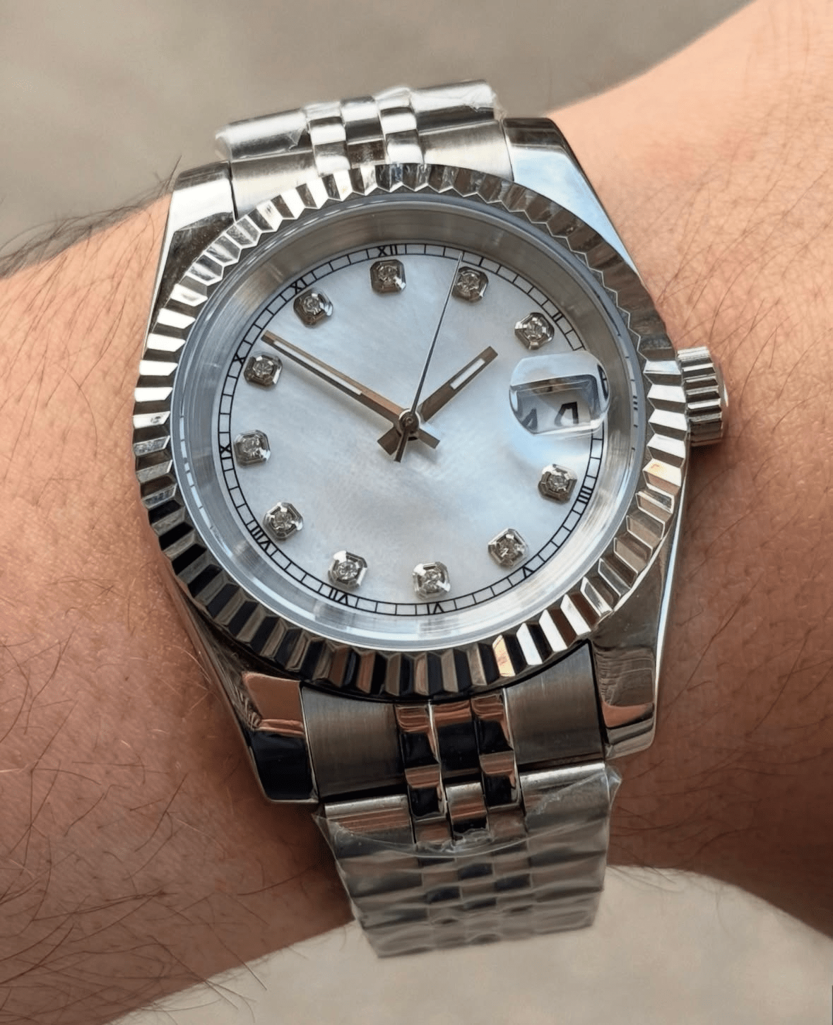 white diamond dial stainless steel Seiko NH35 mod watch on jubilee bracelet, wrist shot no logo