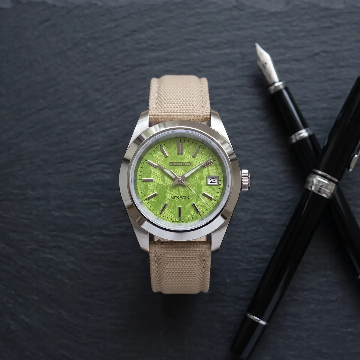 Seiko Mod Uhr DATE MOD | Grünes Struktur-Zifferblatt – Textilarmband – Automatik – Flatlay auf Schiefer – MedoMods
