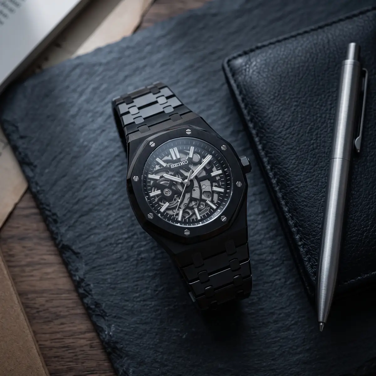 Seiko Mod Uhr OAK MOD – SCHWARZES SKELETON – Flatlay auf Schiefer – MedoMods